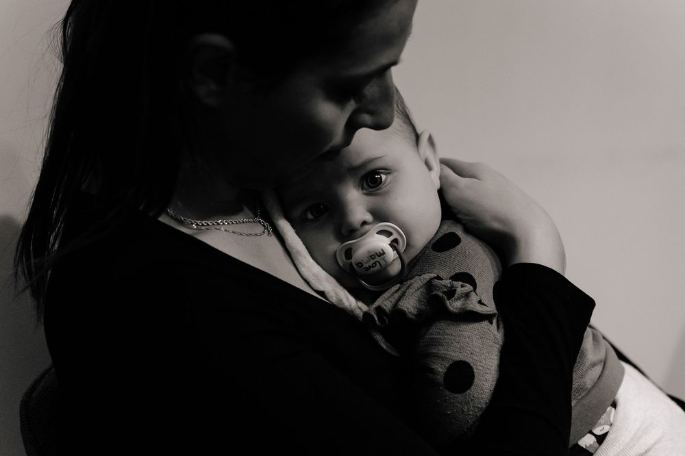 A romantic black and white photo series showing intimate moments between a couple in tender embraces.