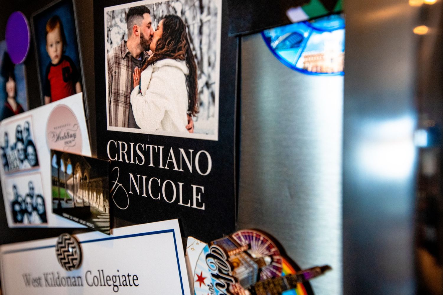 Wall display featuring illuminated signs and collegiate memorabilia in a dimly lit setting.