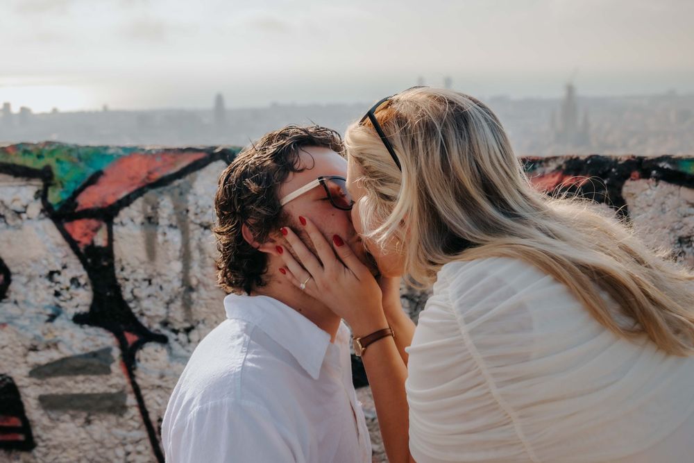Intimate moment of forehead touch with blue sky background.