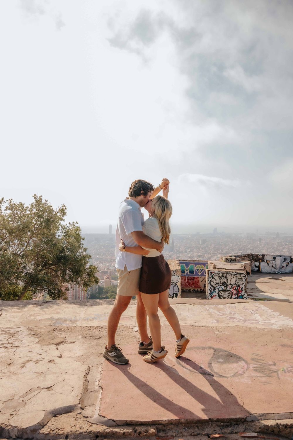 Couple holding hands walking down the concrete steps of the Bunkers.