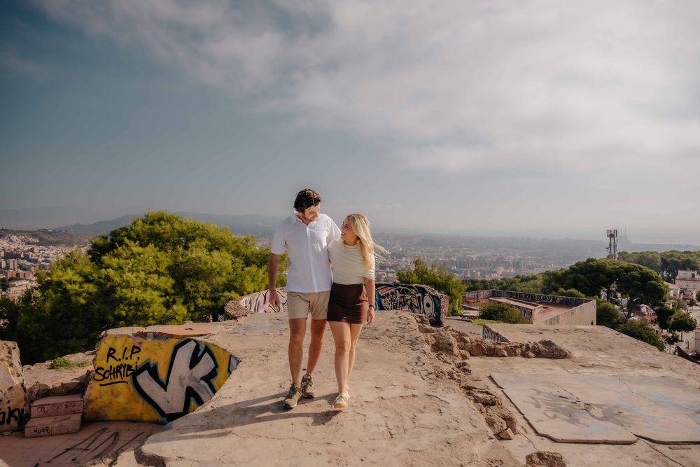 Wide shot of couple standing alone on the hilltop after family left.
