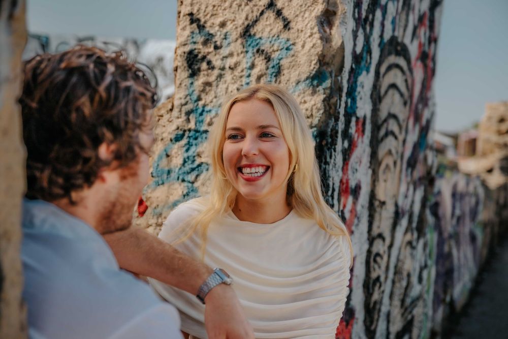 Natural couples photoshoot Barcelona with wind in hair and city views.