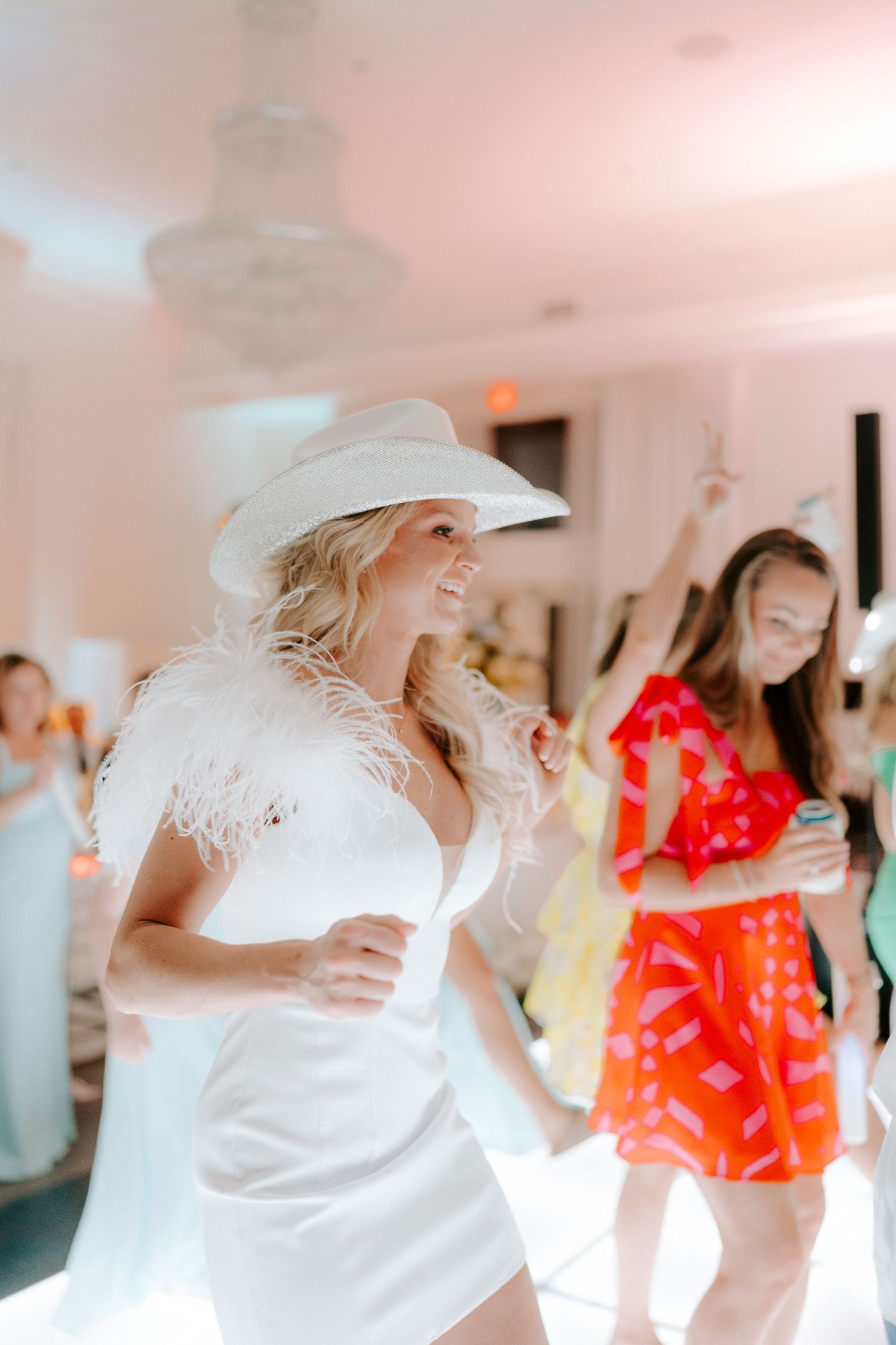Bride in a cowboy hat dances with guests at her wedding reception at The Ballroom at I-Street.