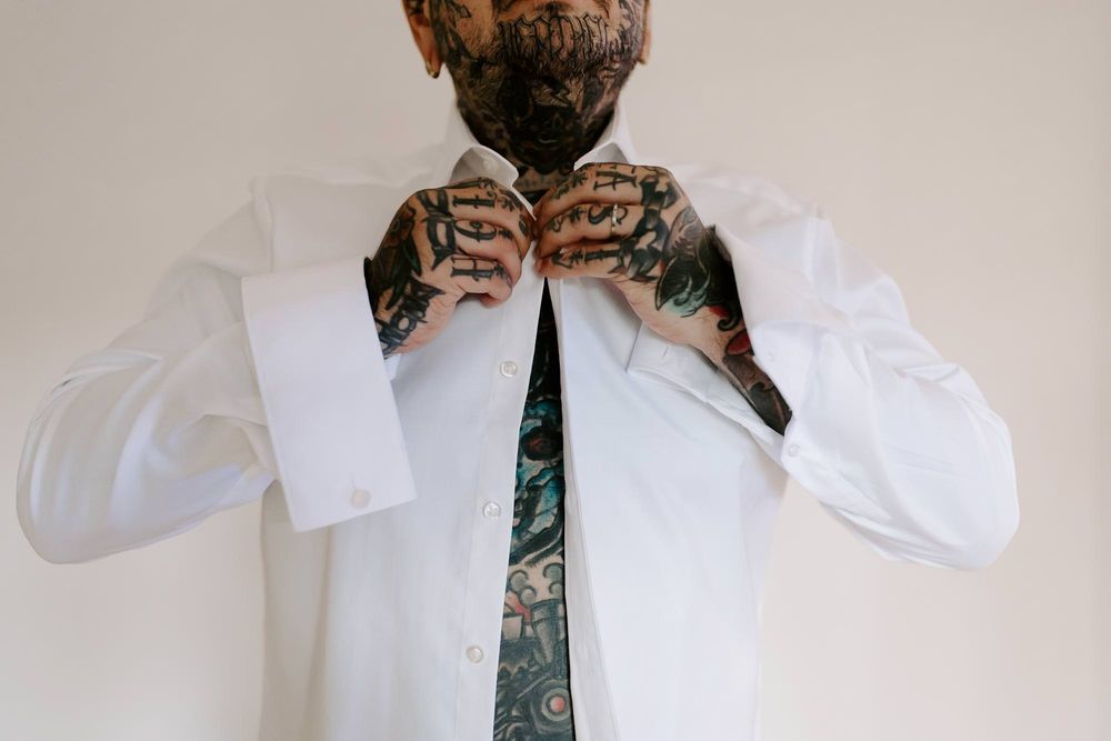 A sequence of photos showing someone in a white collared shirt adjusting their green floral necktie.