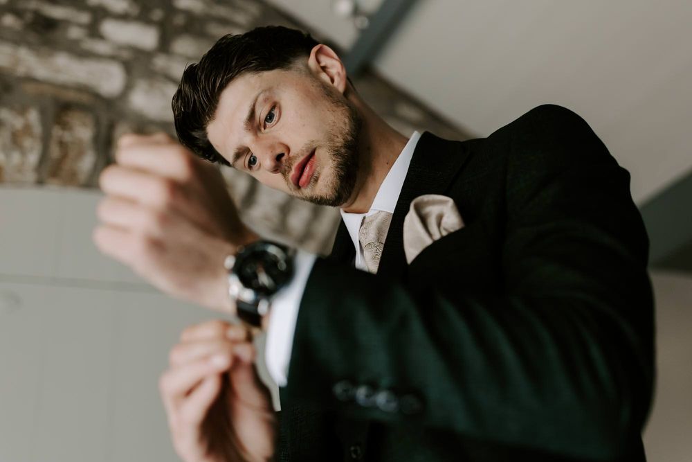 A series of moody black and white photos showing intimate moments of a couple in formal attire.