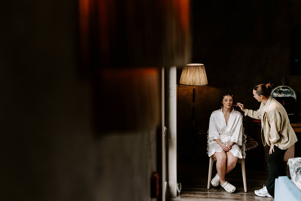 A collection of intimate wedding preparation moments captured in moody, dark lighting with romantic ambiance.