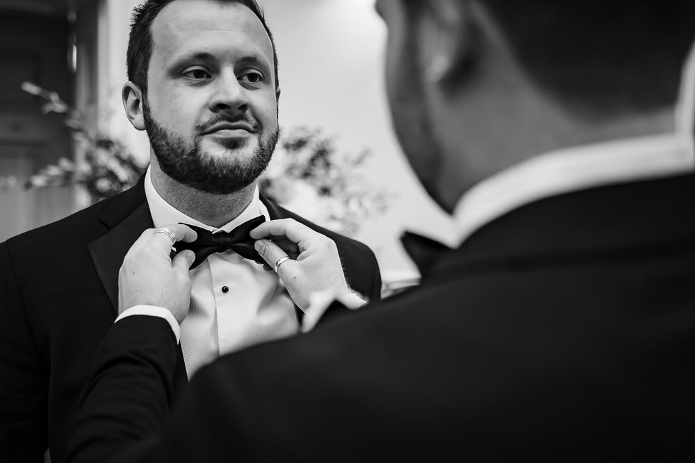 A collection of black and white wedding photography moments showing couples in formal attire during their celebration.