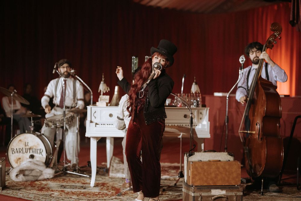 A vintage-style sepia toned photo series showing performers in suspenders on stage with musical instruments and props.
