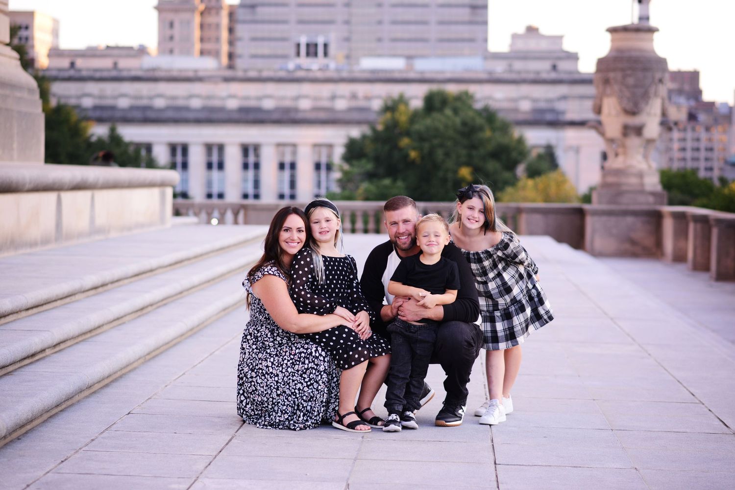 A series of candid outdoor family photos taken on stone steps with people sitting and smiling together.