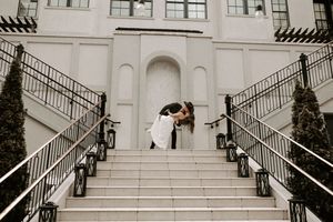 Elegant architectural setting frames romantic wedding photo series with white staircase.