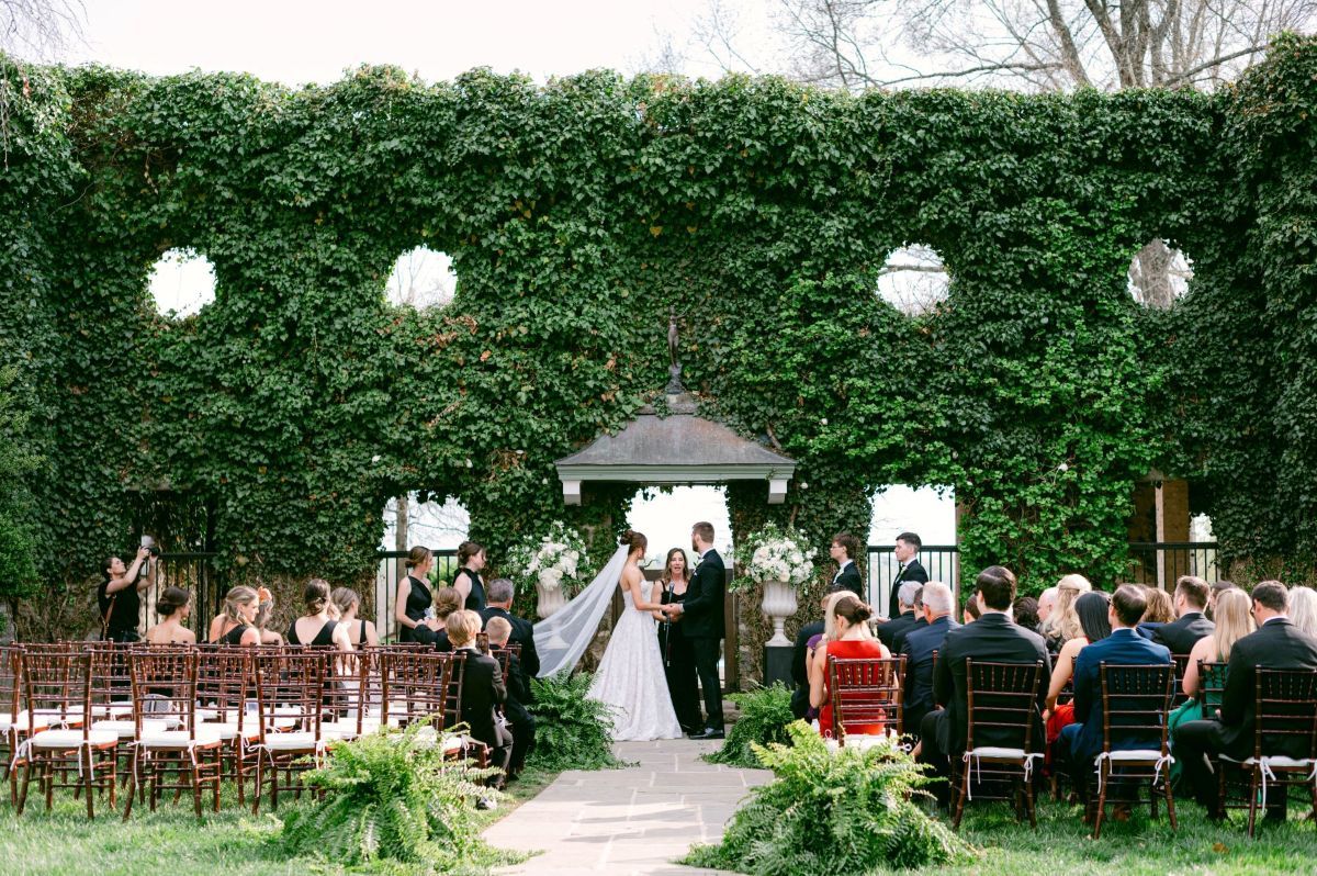 Wedding ceremony in front of green leaf wall at Goodstone Inn, Virginia