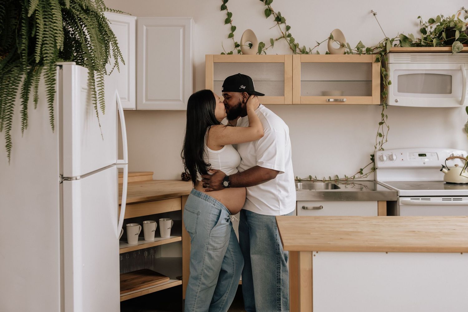 Partner embracing expecting mother during Rochester maternity session