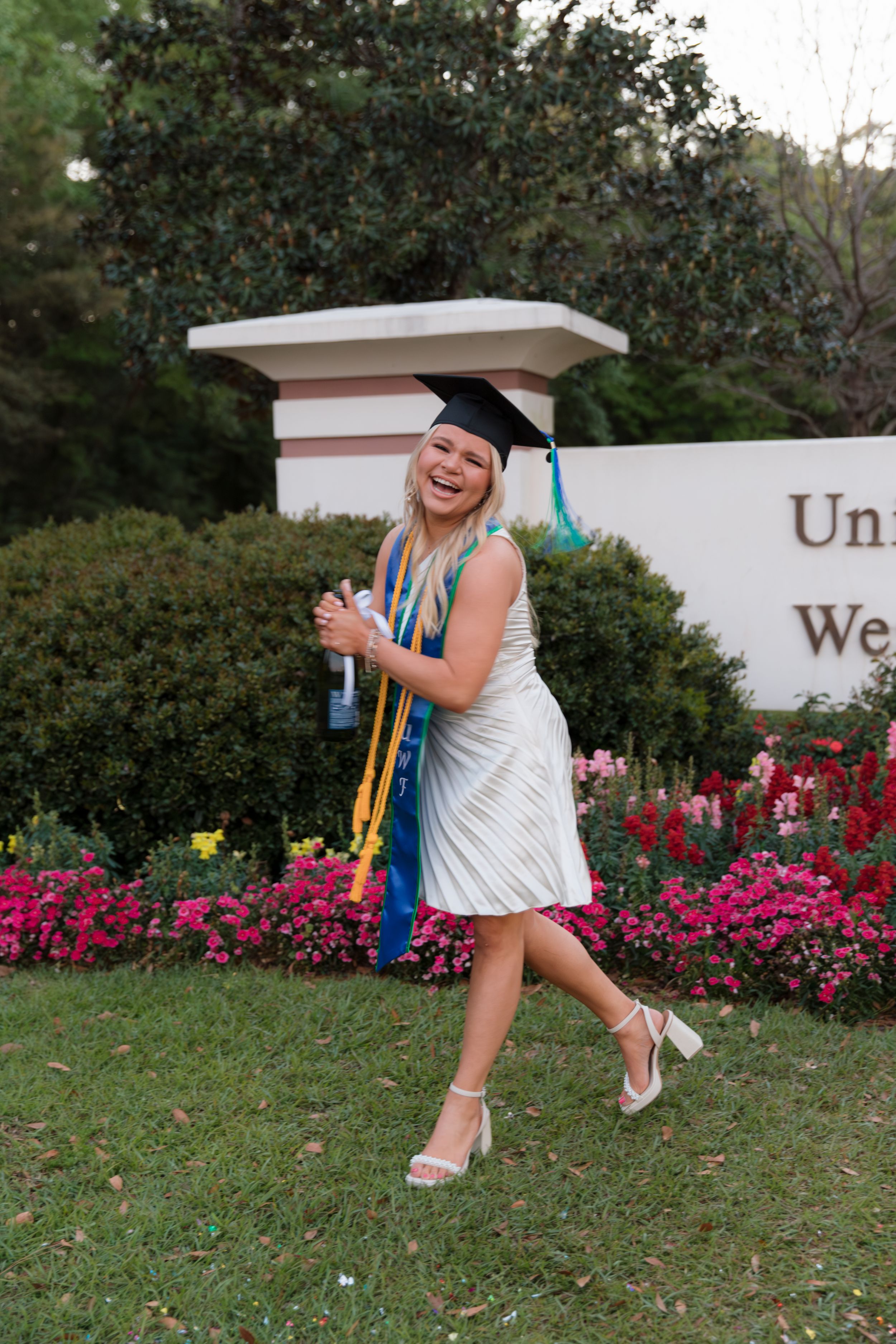 A sequence of photos showing someone falling backwards onto grass near a flowerbed and decorative wall.