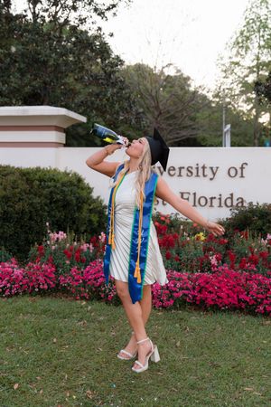 A series of graduation photos taken at the University of Florida campus with bright pink azalea flowers in the background.