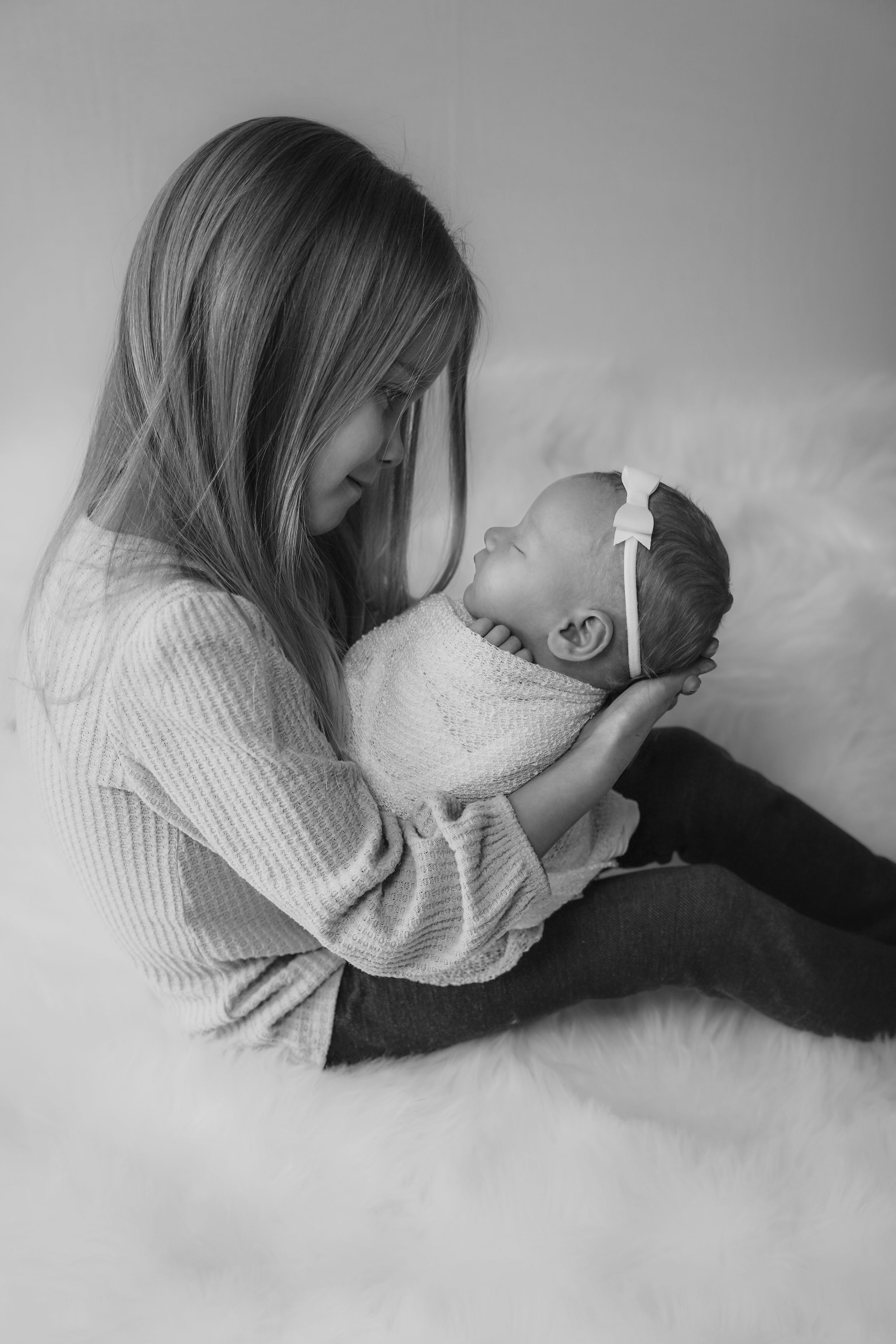 Newborn baby girl with sister