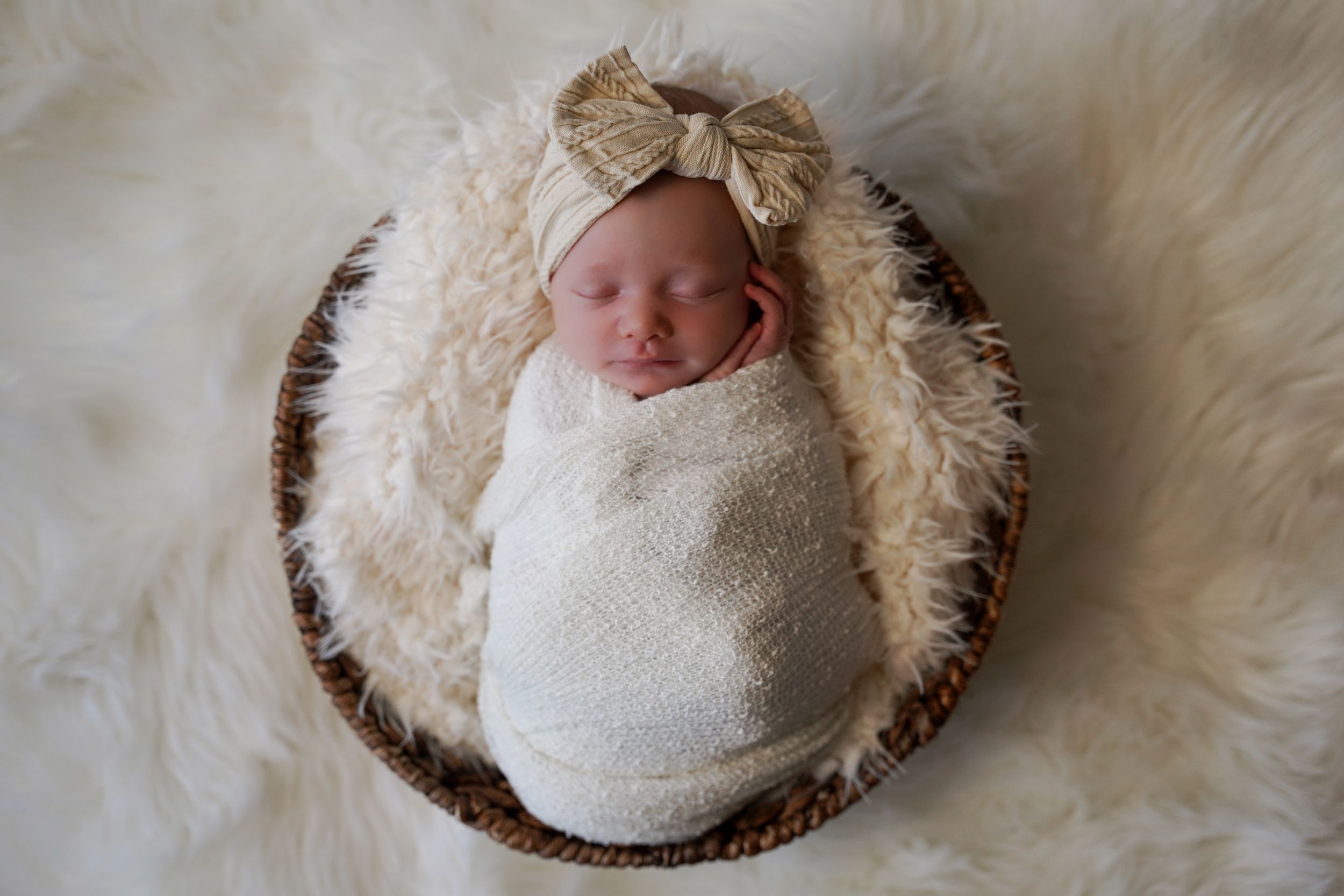 Newborn baby girl in a basket