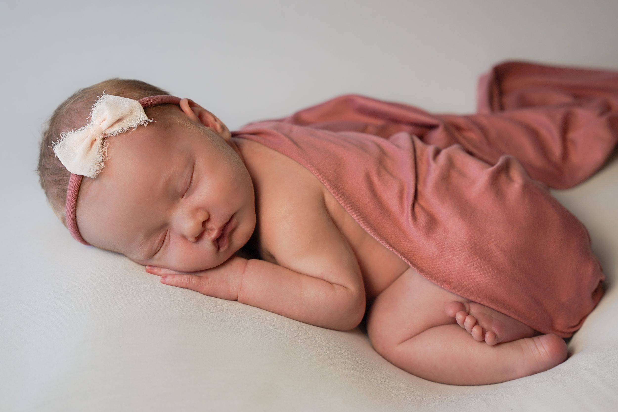 Newborn baby girl bum up pose