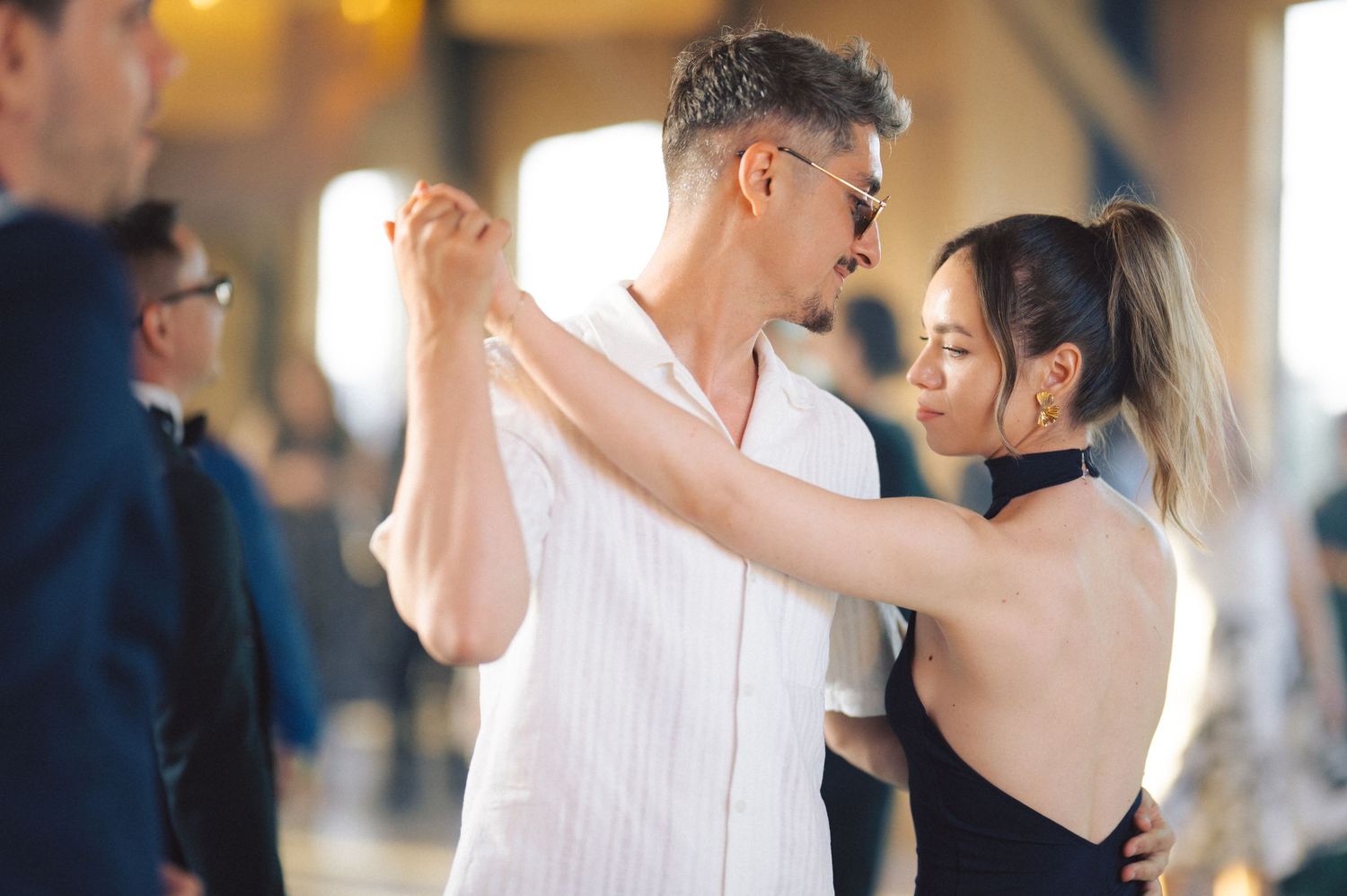 Two dancers practicing their form during a ballroom dance lesson.