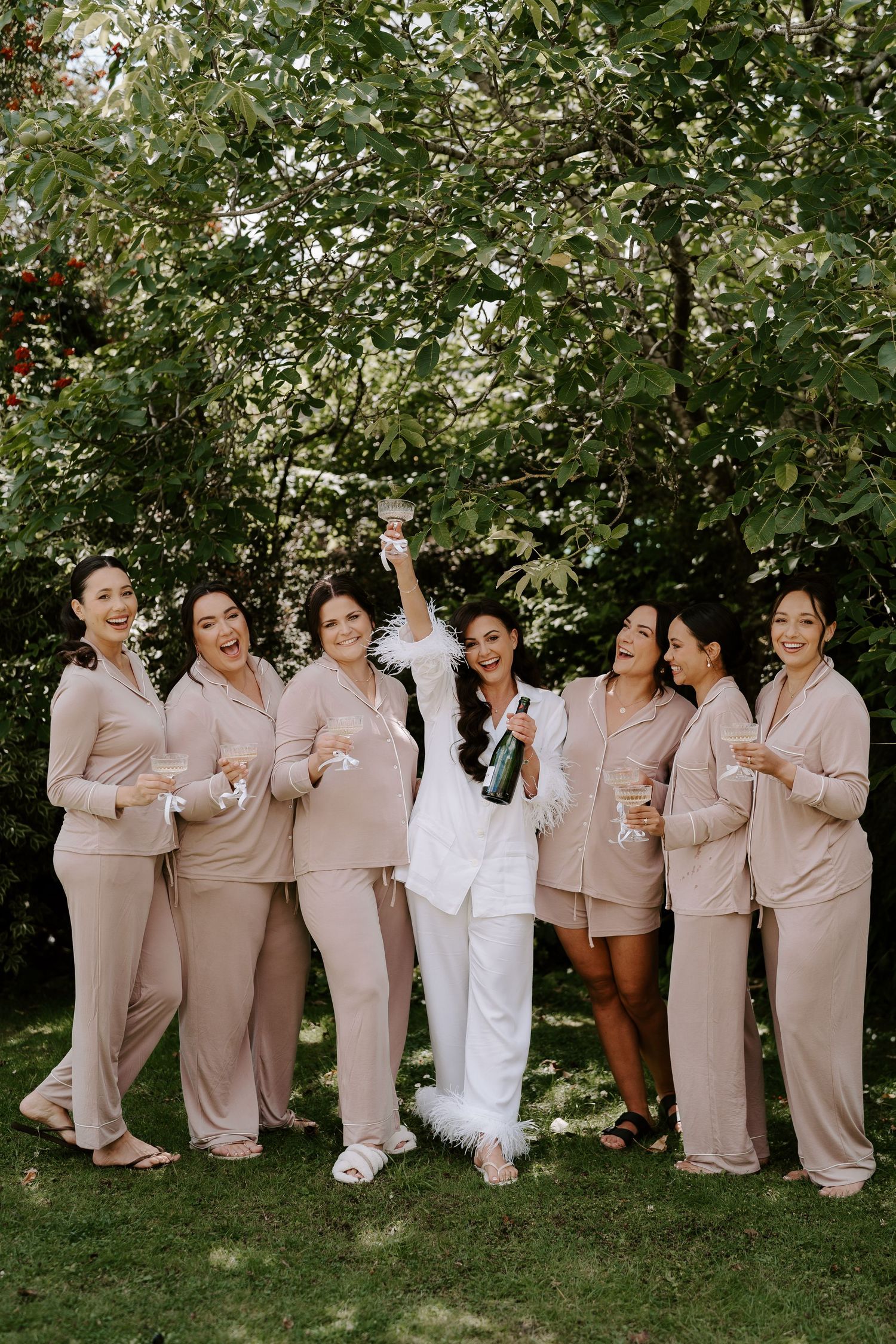 bride and bridesmaids cheering with champagne at the new inn cirencester