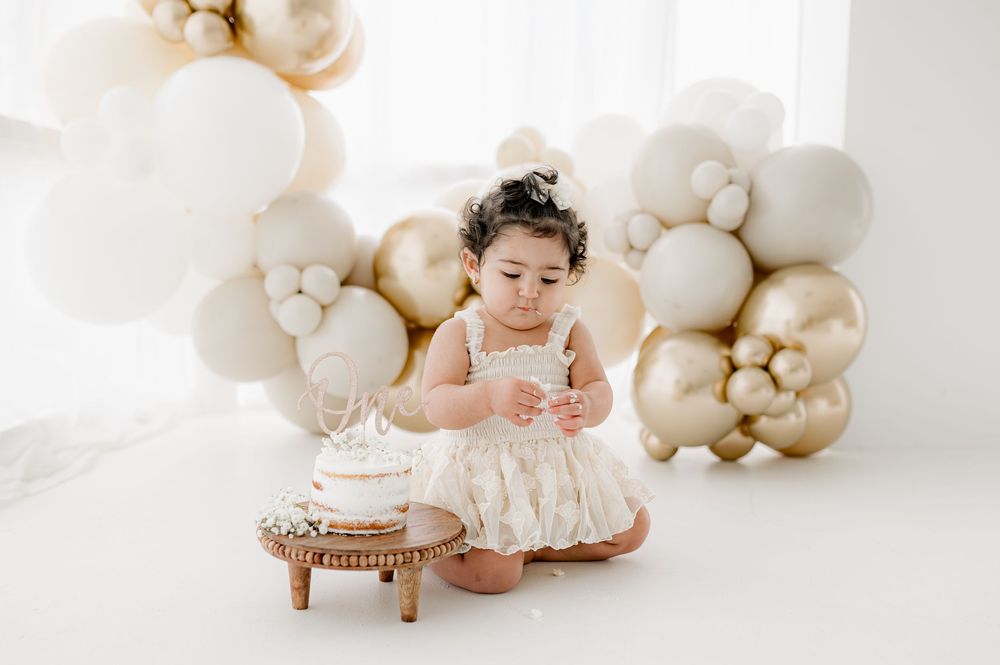 A series of muted cream and beige portrait photographs with white balloons and minimalist styling against a light backdrop.