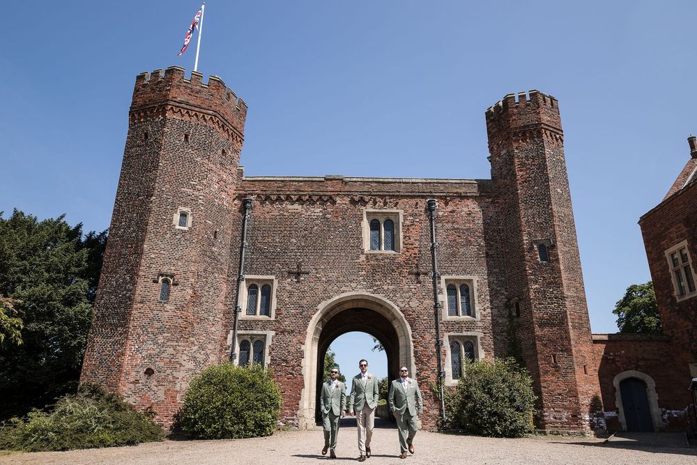 Historic brick castle gate and towers with rustic architectural details at a castle wedding venue.