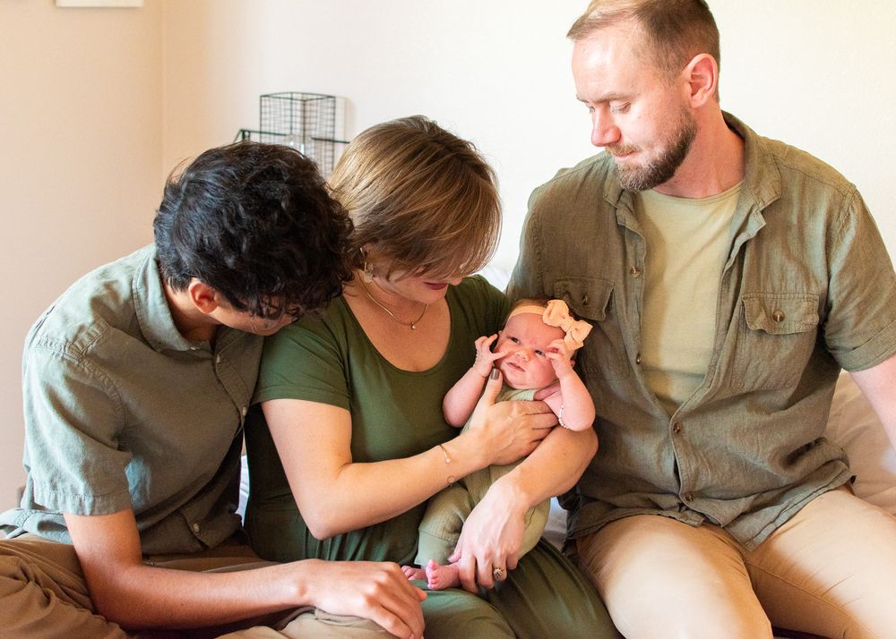 family photo with mom, dad, older brother, and newborn sister