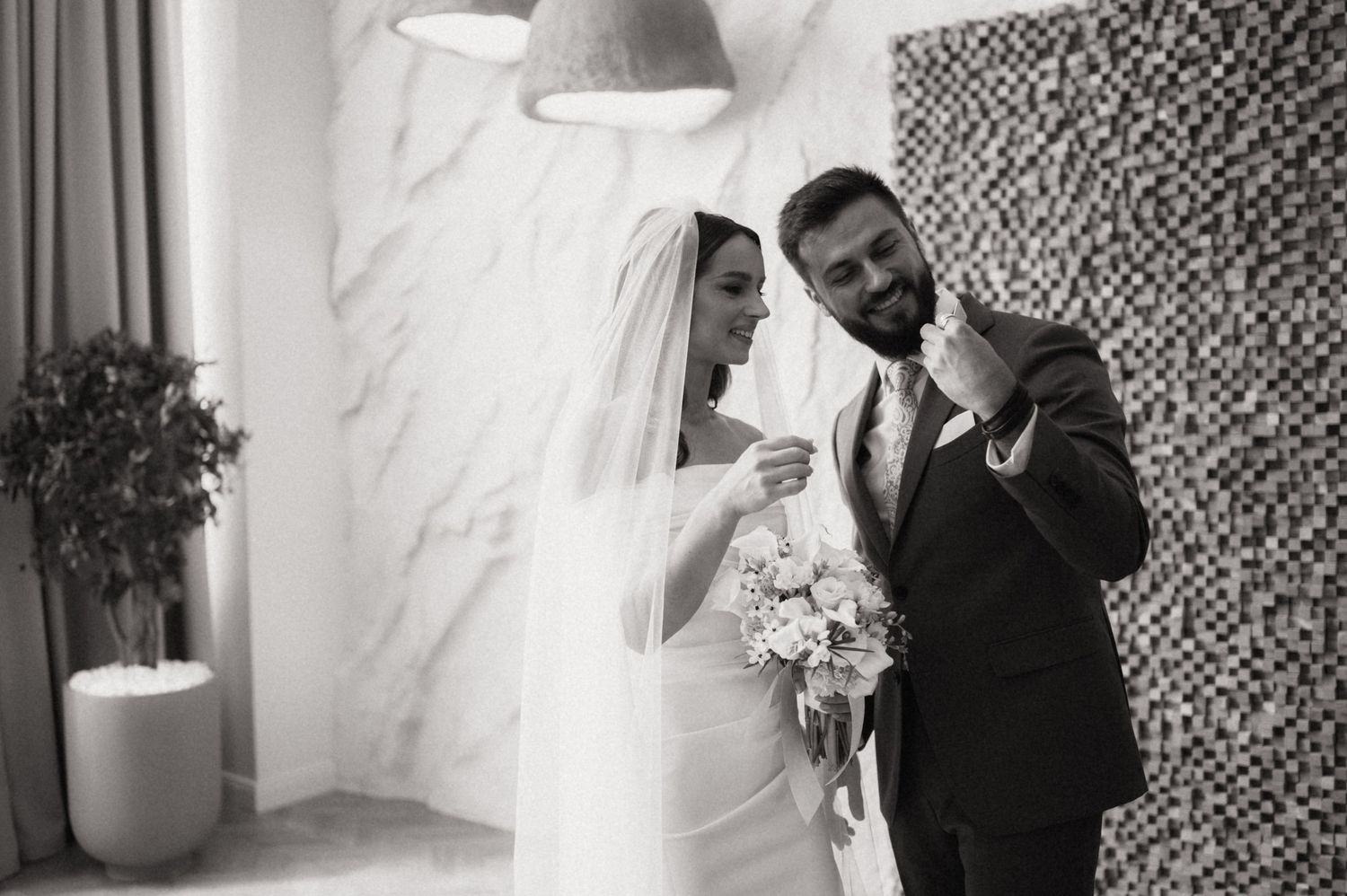 Black and white wedding photos show joyful moments between couples and family members during the celebration.