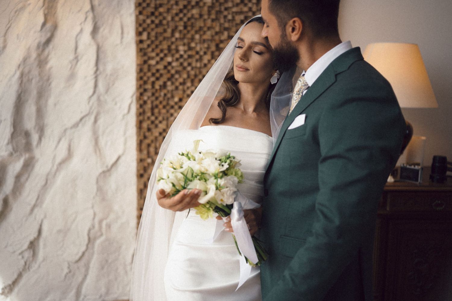 Elegant newlyweds in green suit and white dress embrace in artistic wedding photo sequence.