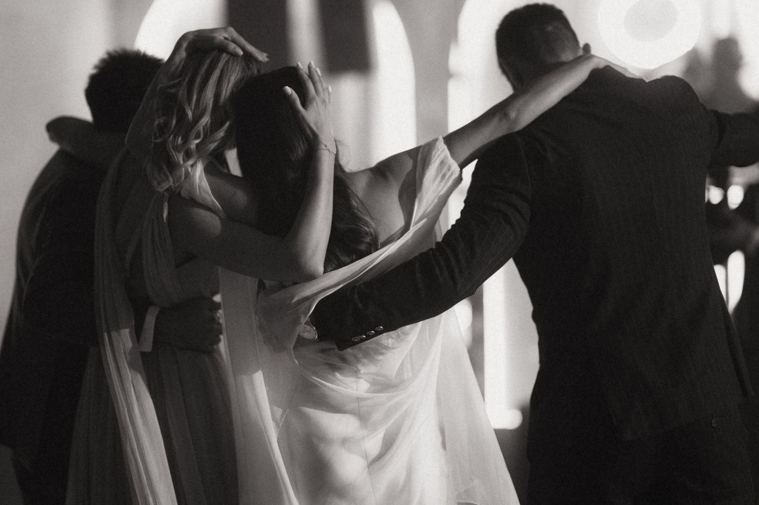 A series of black and white silhouettes show people dancing at what appears to be a wedding or celebration.