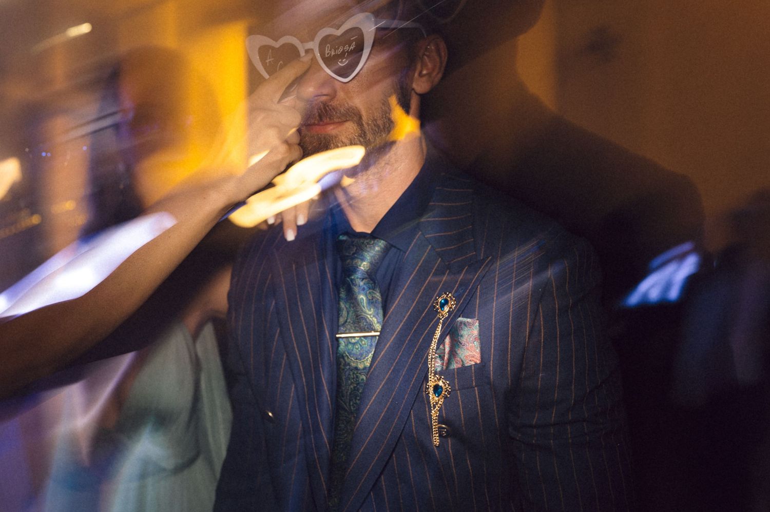 A series of blurred motion photographs with warm orange lighting creates an artistic abstract effect.
