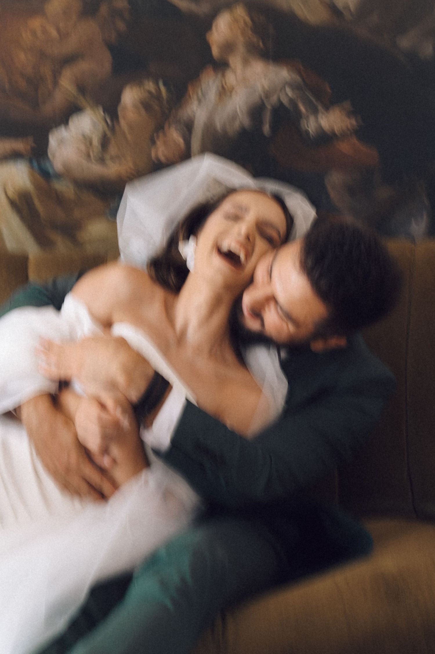 Intimate wedding portrait sequence showing tender moments between couple on antique couch.