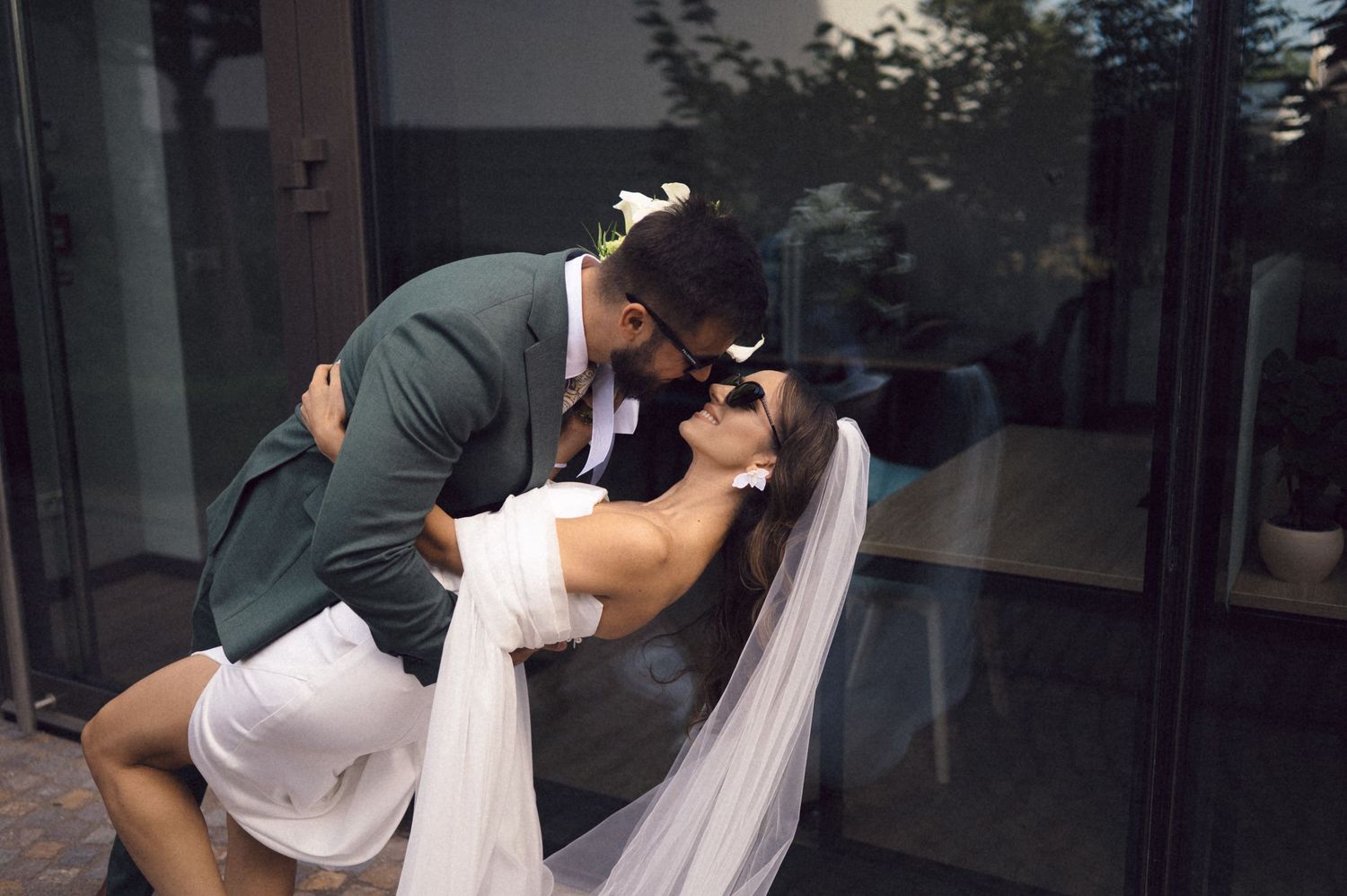 Romantic black and white photo sequence showing couple in wedding attire sharing a passionate kiss.