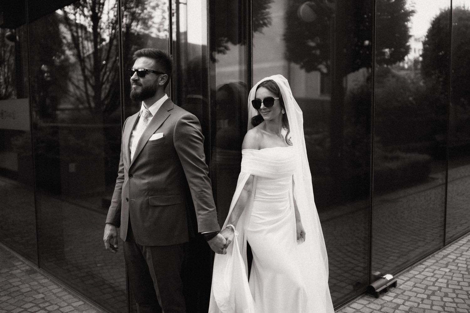 A black and white wedding photo collage showing romantic moments between newlyweds outdoors.