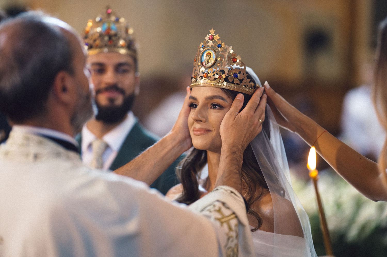 Orthodox wedding ceremony shows a bride and groom wearing ornate gold crowns during the traditional crowning ritual.