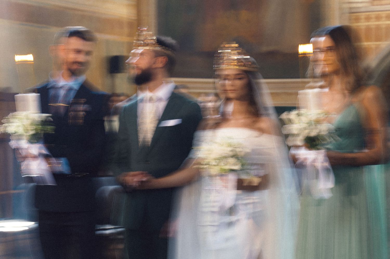 A motion-blurred series of wedding guests dancing and celebrating at a reception party.