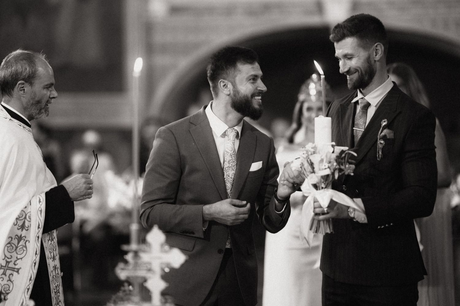 Black and white candid photos show joyful wedding reception moments with guests laughing and celebrating together.
