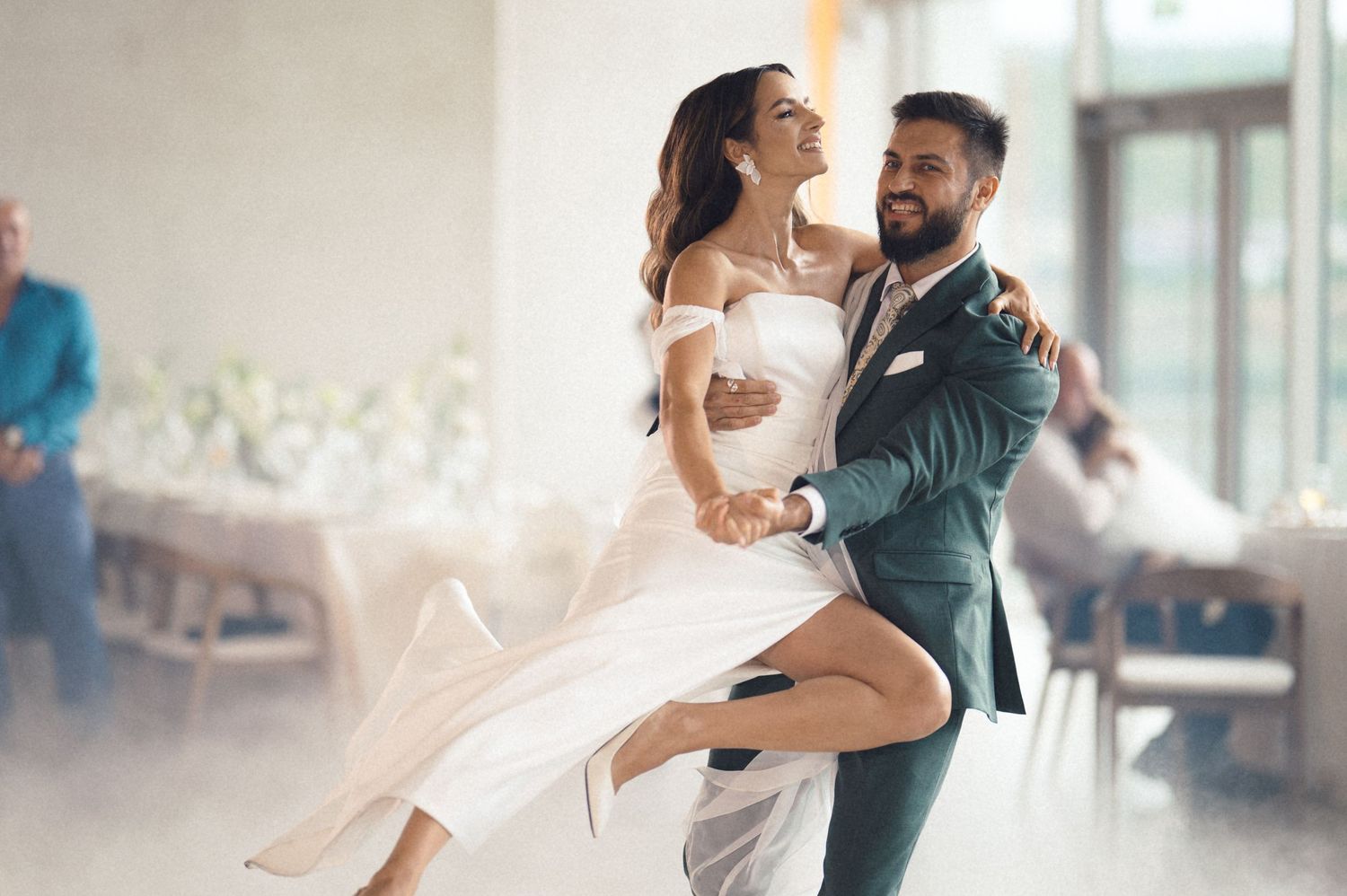 Romantic couples share intimate dance moments on a misty dance floor at a wedding reception.