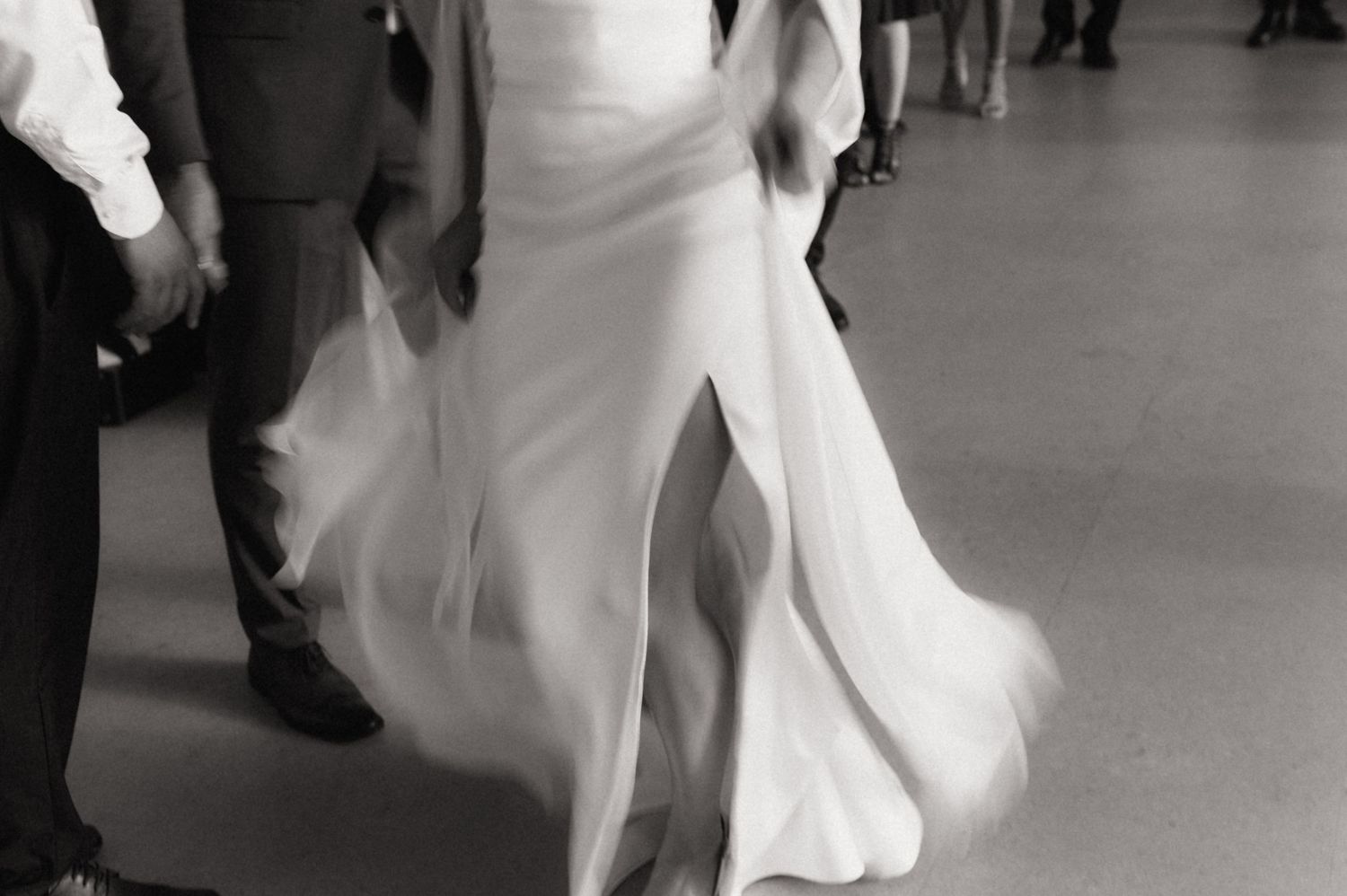 Wedding couple performs their first dance in an elegant ballroom setting.