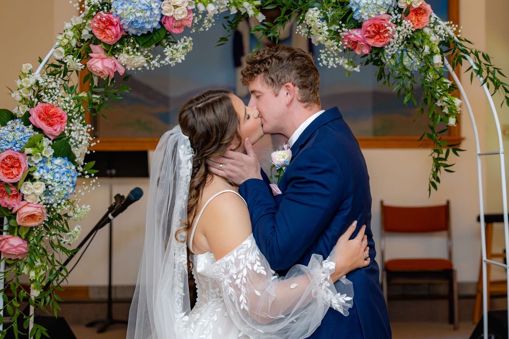 Beautiful wedding collage showing romantic moments with floral arch decorations featuring pink roses and blue hydrangeas.
