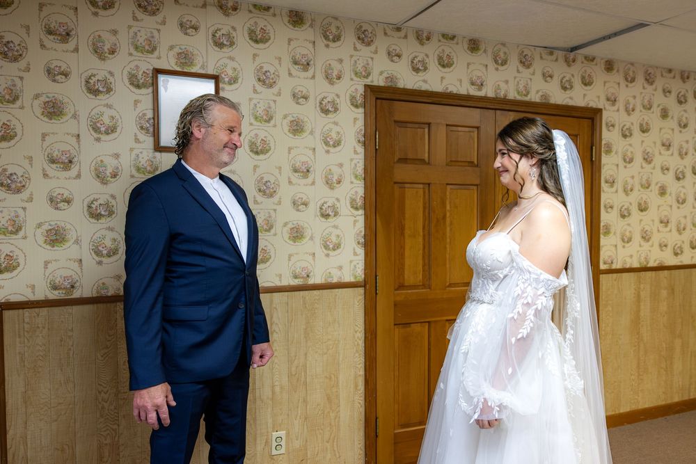 A sequence of four photos showing a bride and groom sharing a first look moment in an elegant wallpapered room.
