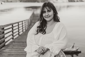 Black and white photo collage showing someone in white clothing posing on a wooden boardwalk or bridge.