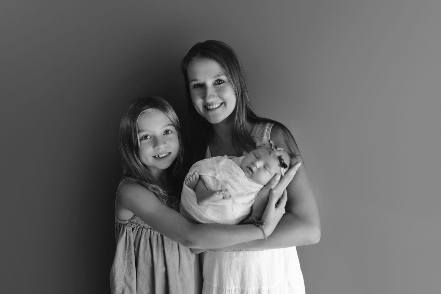 A series of black and white portrait photos showing joyful expressions and candid moments.