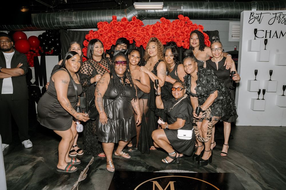 A group of people dancing and socializing at what appears to be a nightclub or party venue.