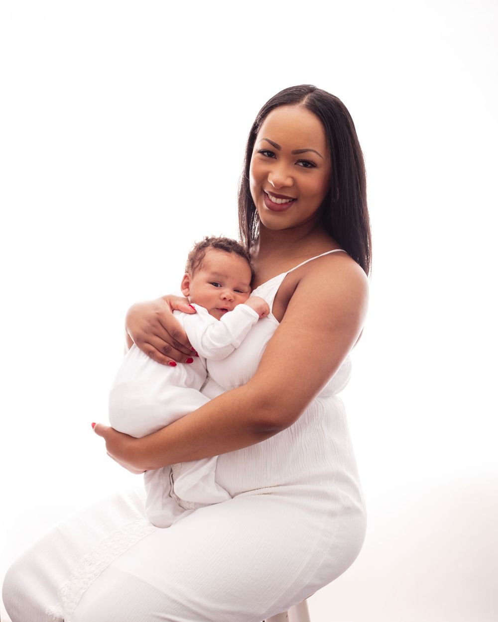 Parent in white dress holds and snuggles with baby in multiple loving poses against white background.