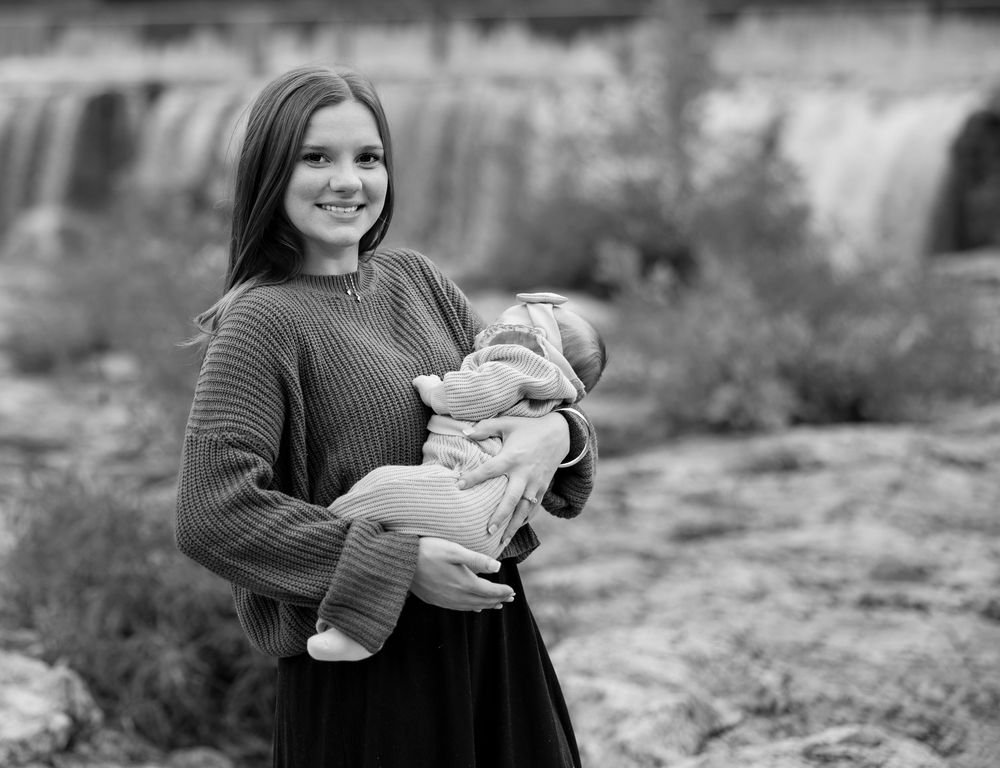 A series of black and white candid family photos showing tender moments between parent and baby outdoors.
