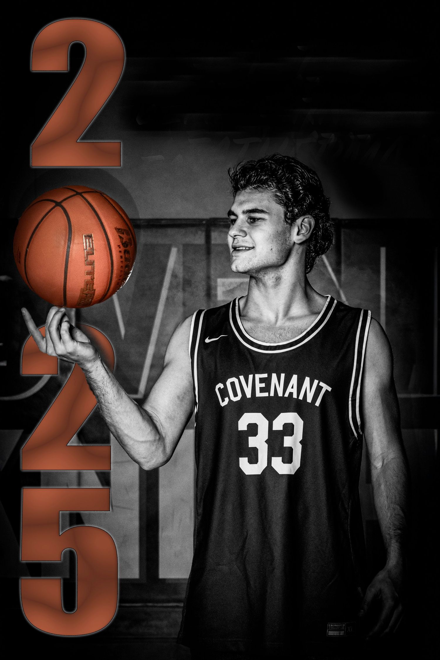 A basketball player in a black Covenant jersey number 33 poses with a basketball against a dark background.