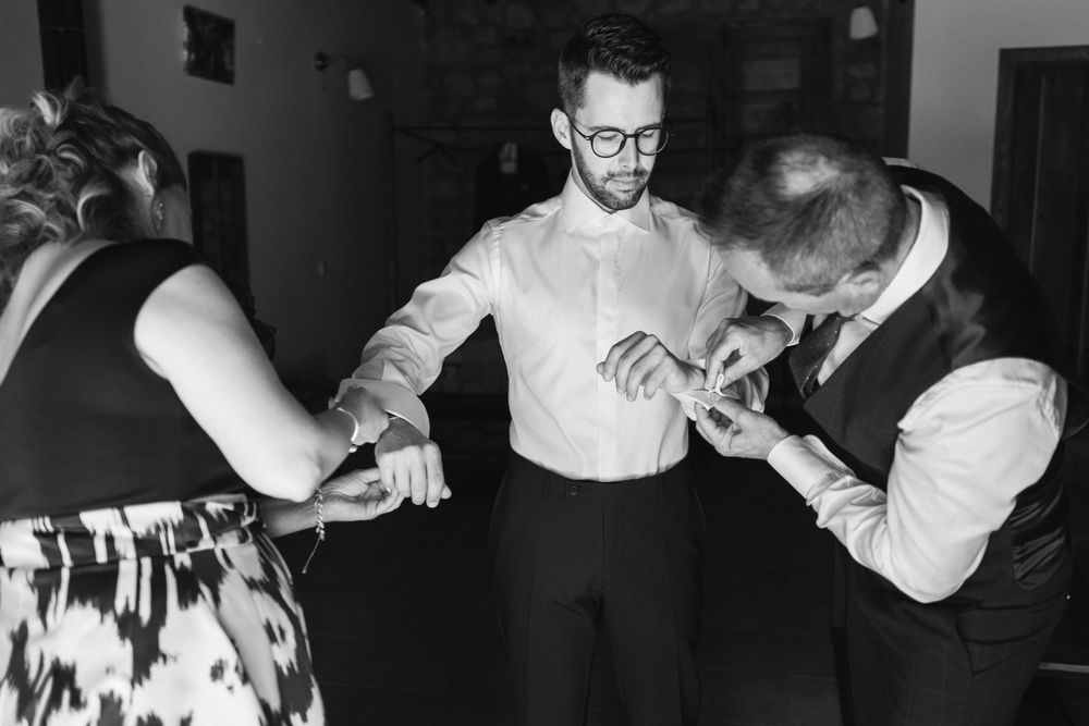 A group of people dancing and socializing at what appears to be an indoor party or gathering in black and white.