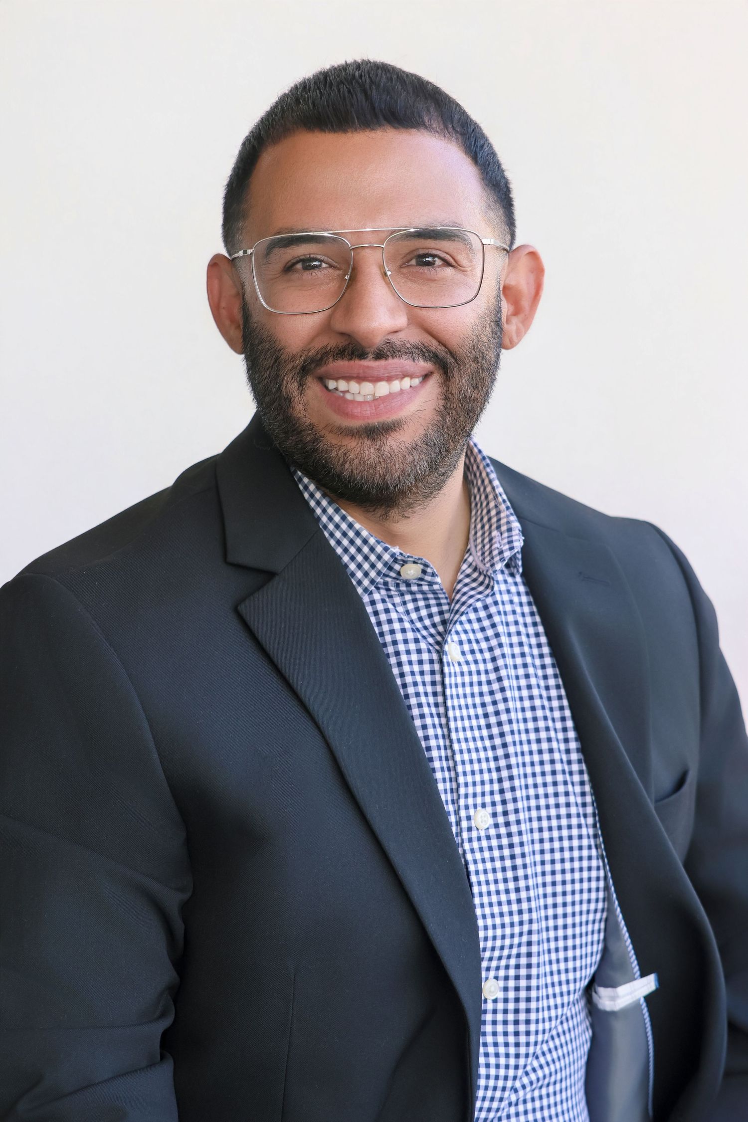 Professional headshot series showing business attire and friendly expressions against white background.