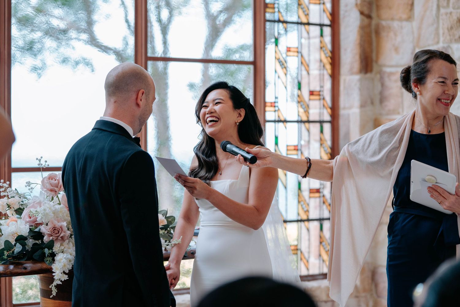 A sequence of candid wedding photos showing joyful moments between couples during a celebration at a venue with stained glass.