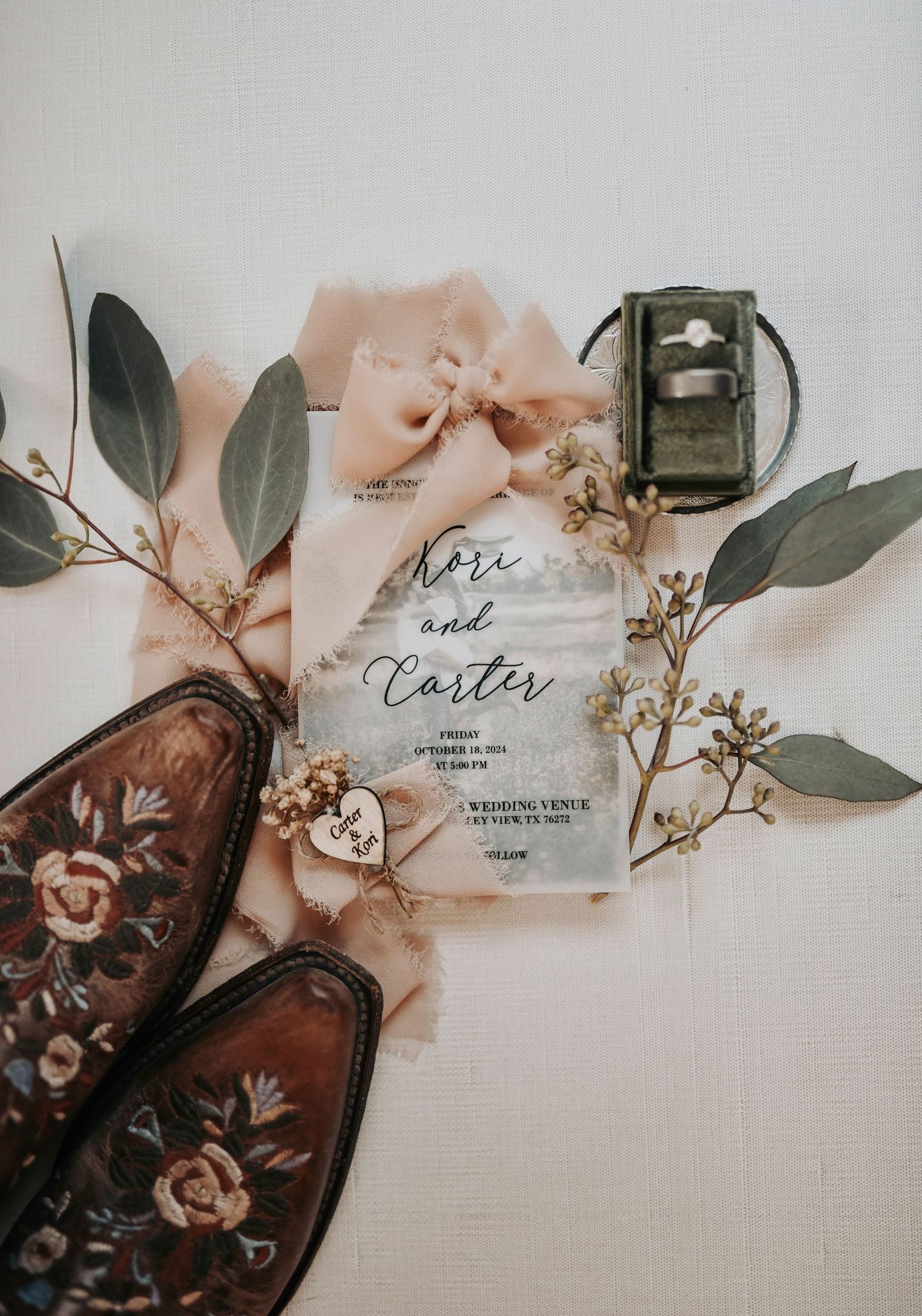 flat lay of invitation and cowgirl boots